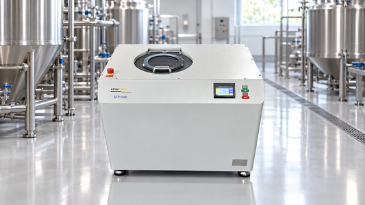 Centrifuge for food and beverage processing shown in a bright, stainless-steel production environment.