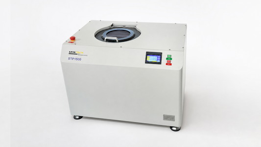 planetary centrifuge vs basket centrifuge: a Spin Tech STP-1500 planetary centrifuge in a clean studio setting.